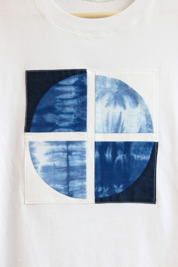 Quilt block securely sewn onto a T-shirt.
